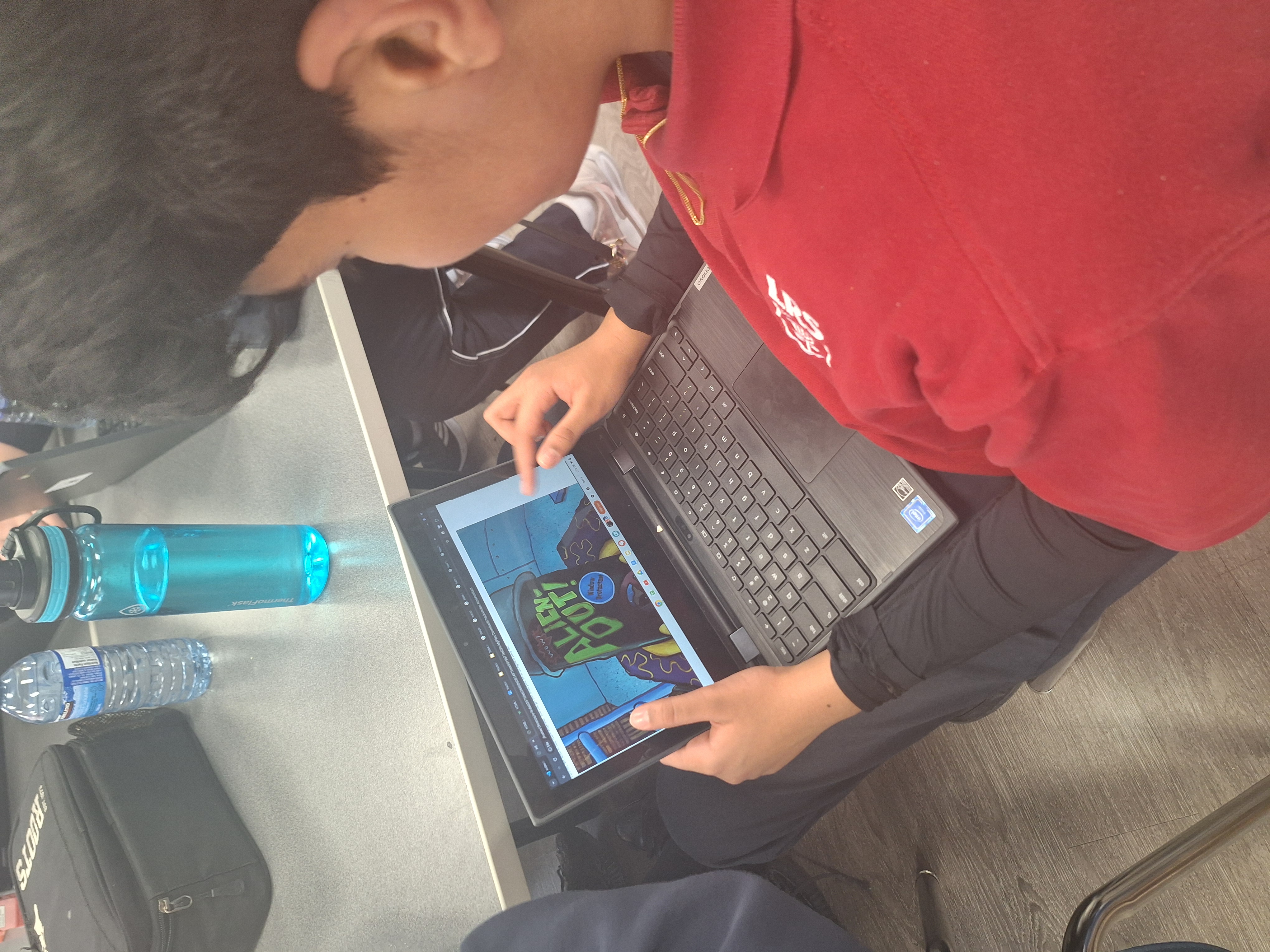 Student designing on a laptop during last year's hackathon